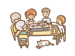 食卓テーブルで焼き肉をする家族