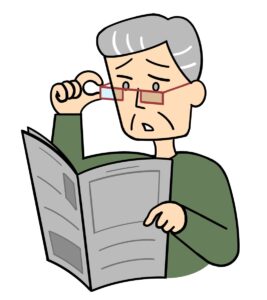 老眼で新聞が読みずらそうな男性